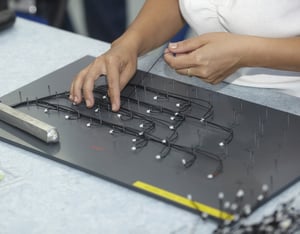 close up of worker hands in electrical cable production for Micro Electro Mechanical Systems